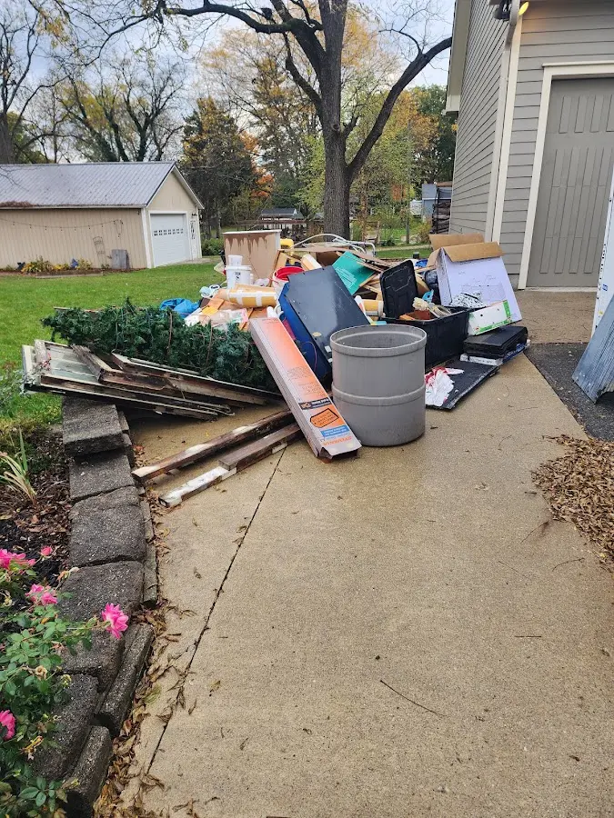 Dumpster being loaded with debris for 30 Yard Dumpster Rental in Plymouth